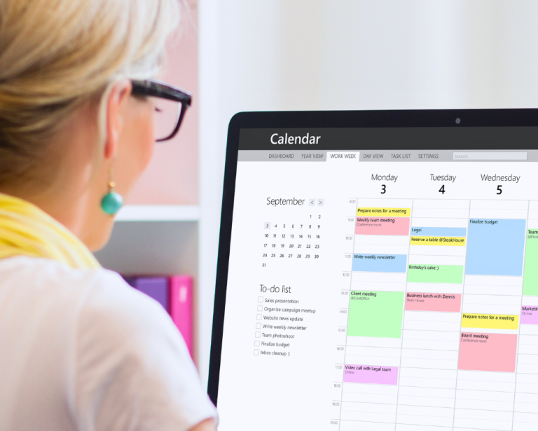 Woman managing calendar on desktop computer.
