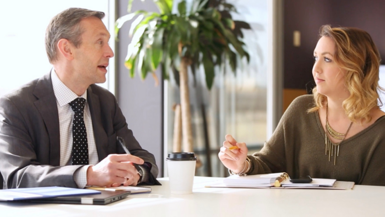 Assistant and executive in meeting.