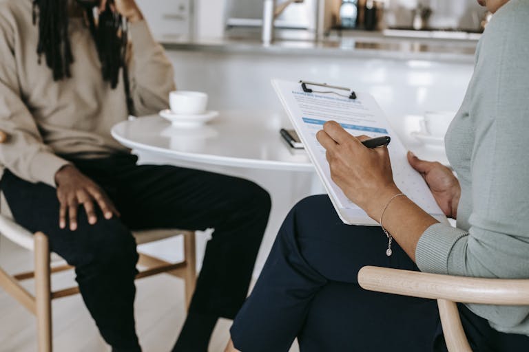 Crop faceless multiethnic interviewer and recruiter going through interview process