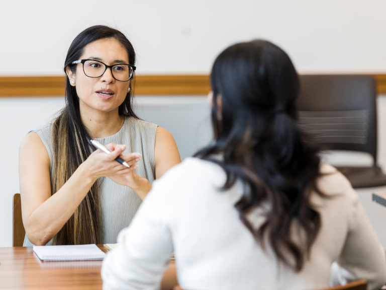 Two businesswomen at a table conducting a job interview