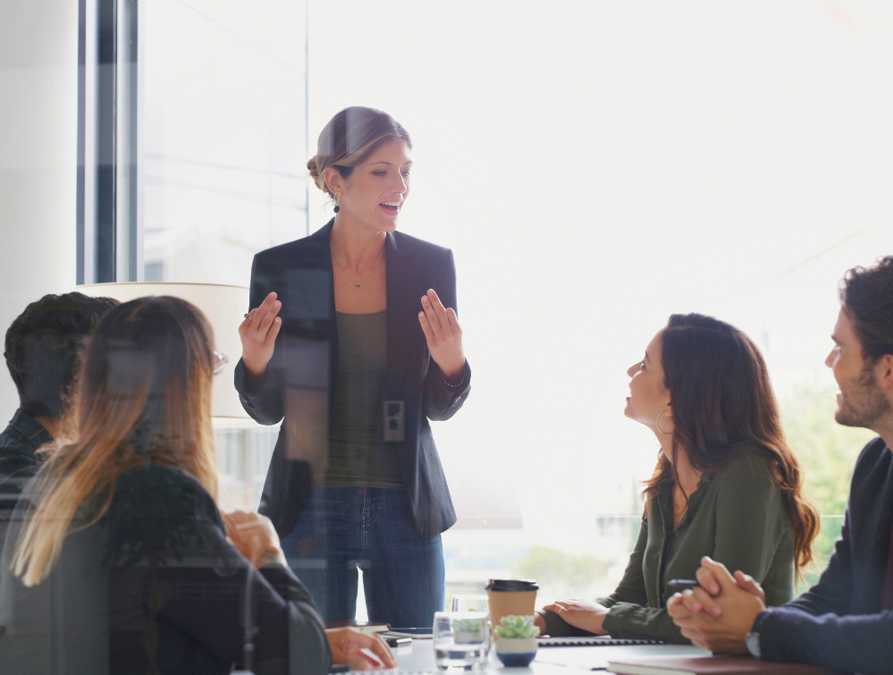 Visionary leader brainstorming with team in a conference room.