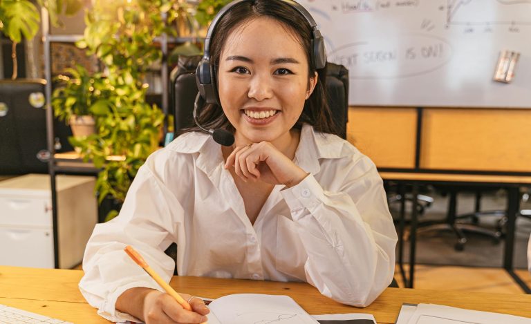 A cheerful virtual assistant wearing a headset, working on documents in office during the holidays.