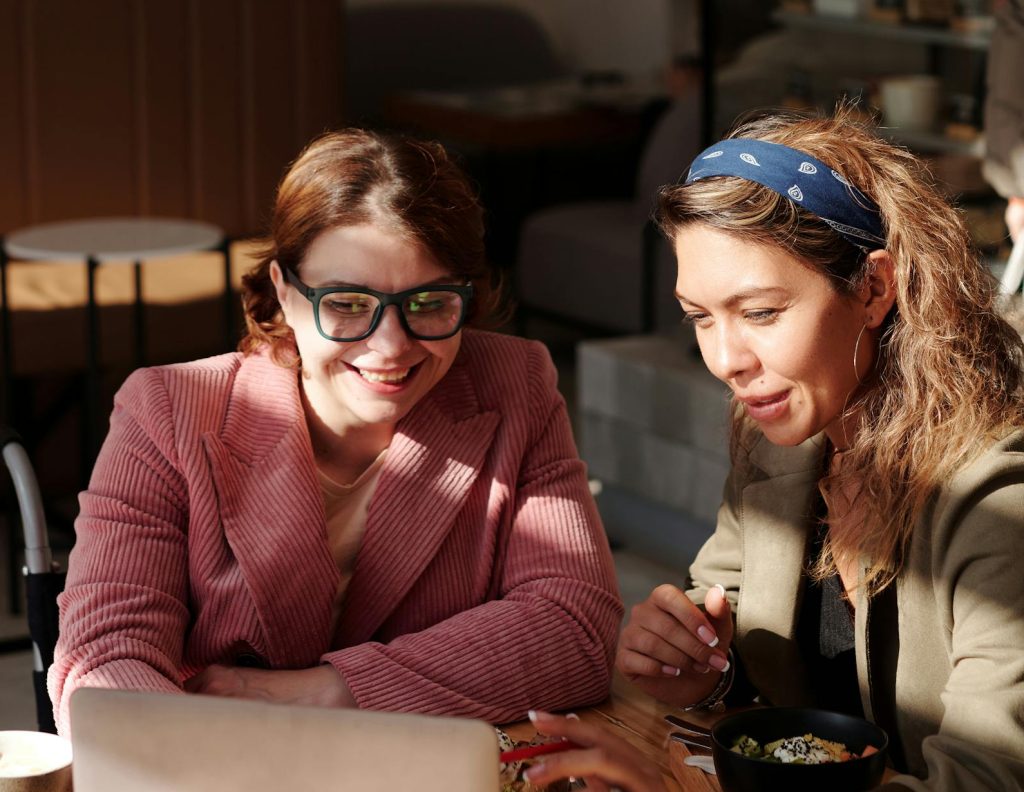 Two professionals engaged in a coaching session, discussing strategies and feedback for growth.