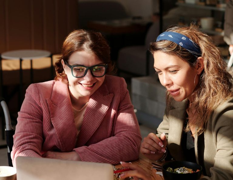 Two professionals engaged in a coaching session, discussing strategies and feedback for growth.
