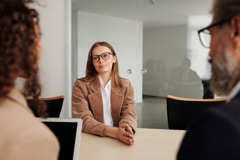 Young woman attending a job interview in a modern office, showcasing confidence and professionalism. But possibly an executive assistant hiring mistake.